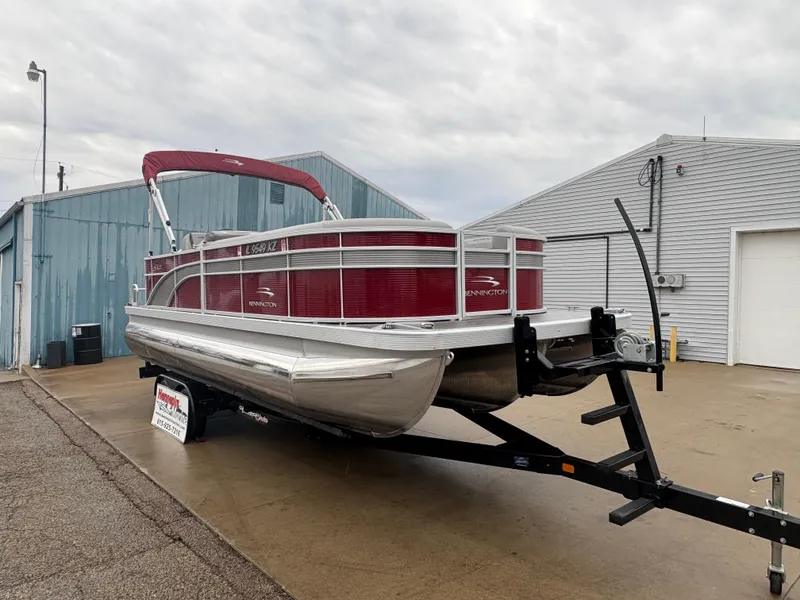 Slide: The Image of 2020 Bennington 22 SLX pontoon boat on trailer, red and silver, parked outside. - 7