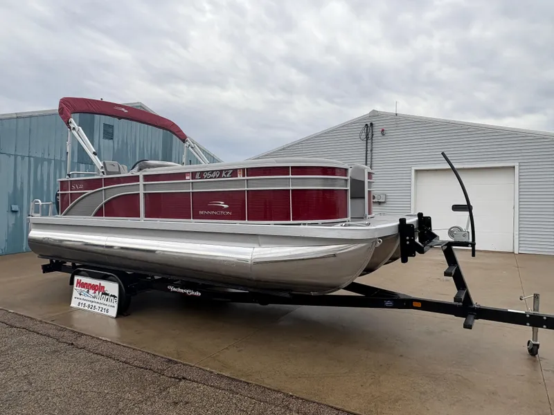 Slide: The Image of 2020 Bennington 22 SLX pontoon boat on trailer, parked outside a building. - 8