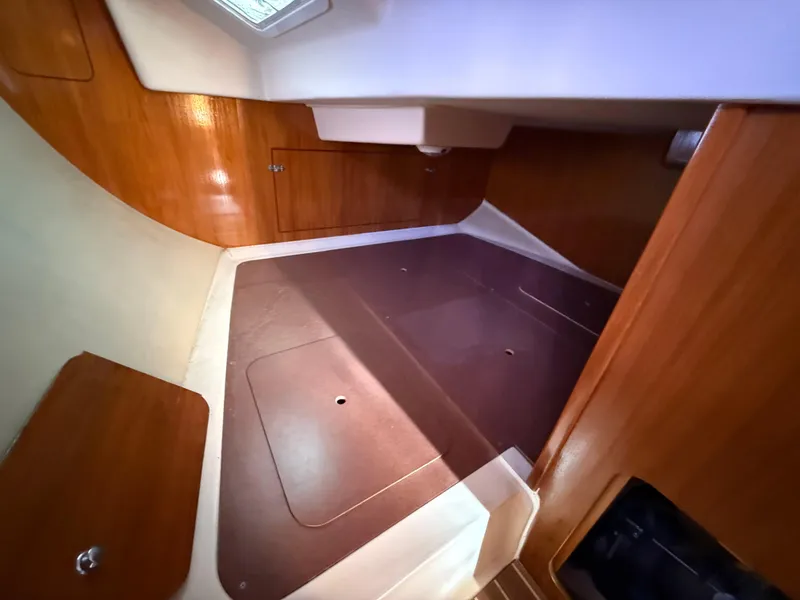 Slide: The Image of Interior cabin of 2007 Hunter 33 sailboat with wooden finish and storage space. - 11