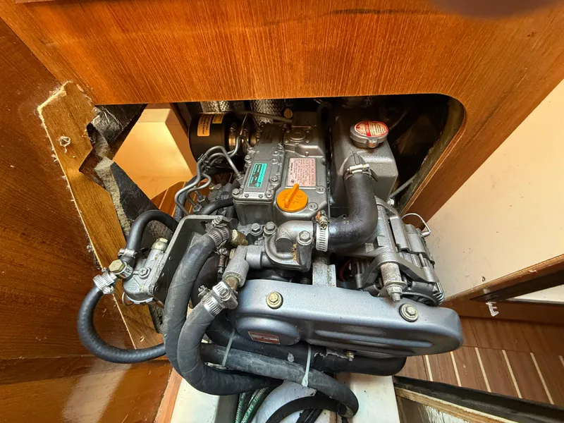Slide: The Image of Engine compartment of a 2007 Hunter 33 sailboat, showcasing detailed mechanical components. - 13