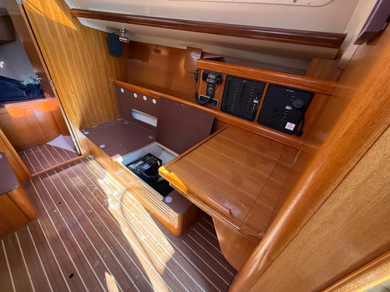 Slide: The Image of Interior of 2007 Hunter 33 sailboat with wooden cabinetry and control panels. - 15