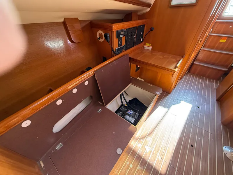 Slide: The Image of Interior of 2007 Hunter 33 sailboat showing open storage compartment and electrical panel. - 19
