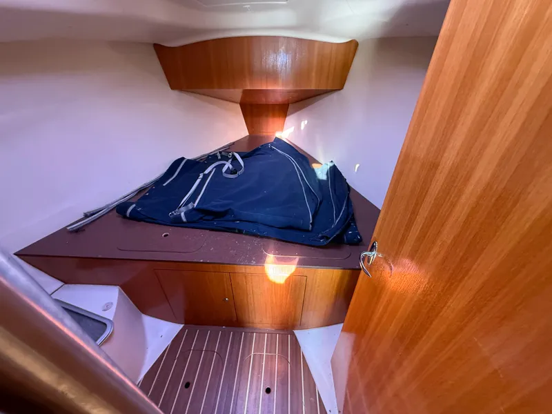 Slide: The Image of 2007 Hunter 33 sailboat interior cabin with wooden finish and folded sail. - 20