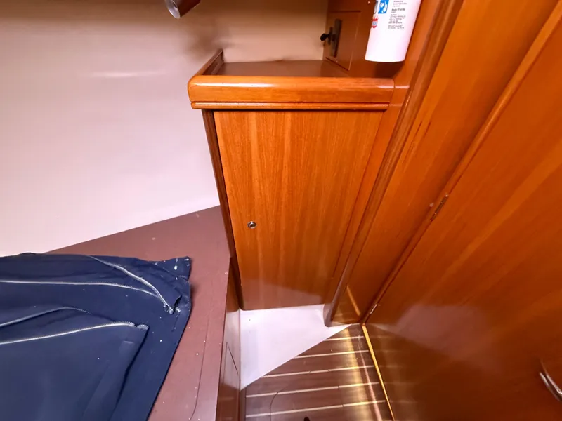 Slide: The Image of Interior of a 2007 Hunter 33 sailboat, featuring wooden cabinetry and flooring. - 22