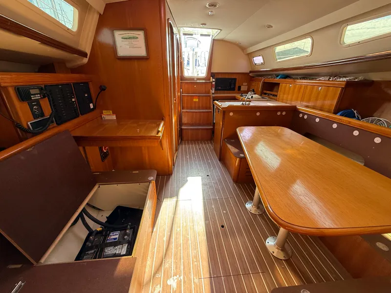 Slide: The Image of Interior of 2007 Hunter 33 sailboat with wooden furnishings and seating area. - 24