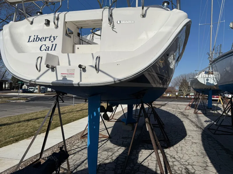 Slide: The Image of 2007 Hunter 33 sailboat "Liberty Call" on stands, outdoor storage. - 30