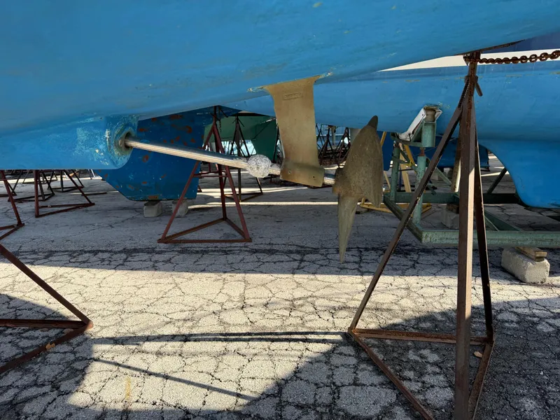 Slide: The Image of 2007 Hunter 33 sailboat hull and propeller on stands, blue paint visible. - 38