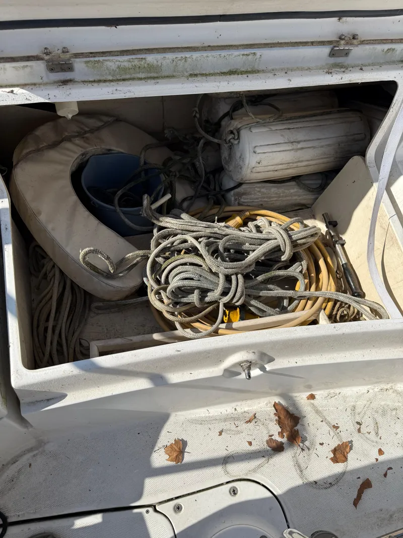 Slide: The Image of Storage compartment on a 2007 Hunter 33 boat with ropes and equipment. - 44