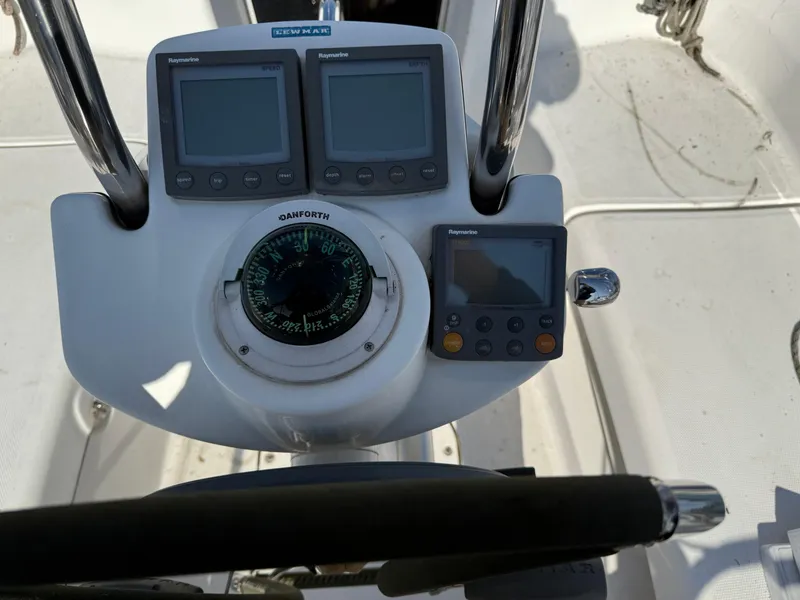 Slide: The Image of Cockpit instruments of a 2007 Hunter 33 sailboat, featuring navigation displays and a compass. - 49