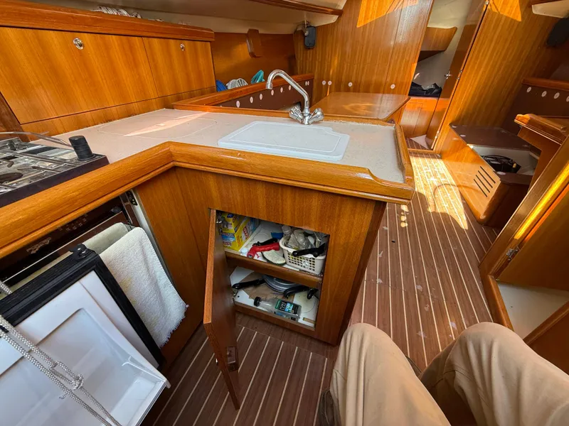 Slide: The Image of Interior of 2007 Hunter 33 sailboat kitchen with wood cabinetry and sink. - 8