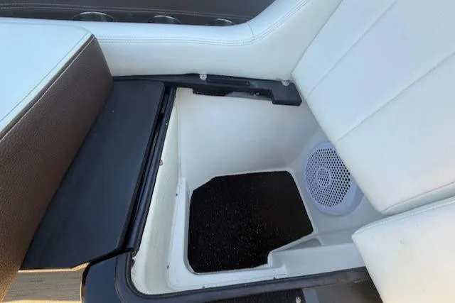 Slide: The Image of 2016 Regal 2800 Bowrider interior seating with storage compartment and speaker. - 20