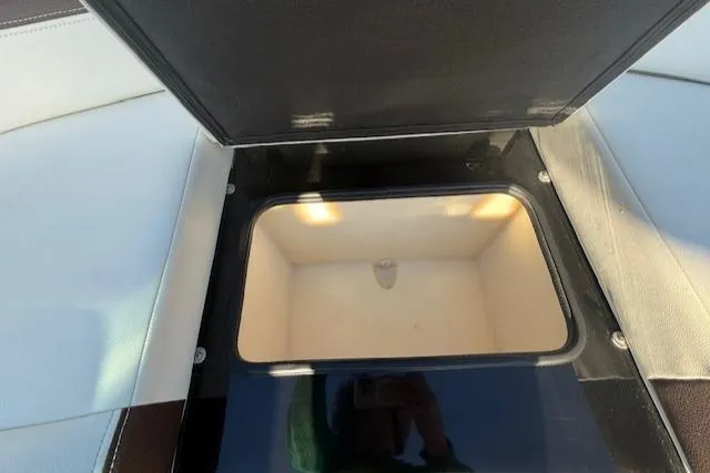 Slide: The Image of Open storage compartment in 2016 Regal 2800 Bowrider boat. - 21