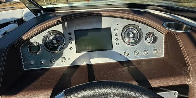 Slide: The Image of Dashboard of a 2016 Regal 2800 Bowrider boat with gauges and controls. - 24