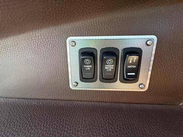 Slide: The Image of Control panel on 2016 Regal 2800 Bowrider boat with switches for tower lights, underwater lights, and hatch. - 25