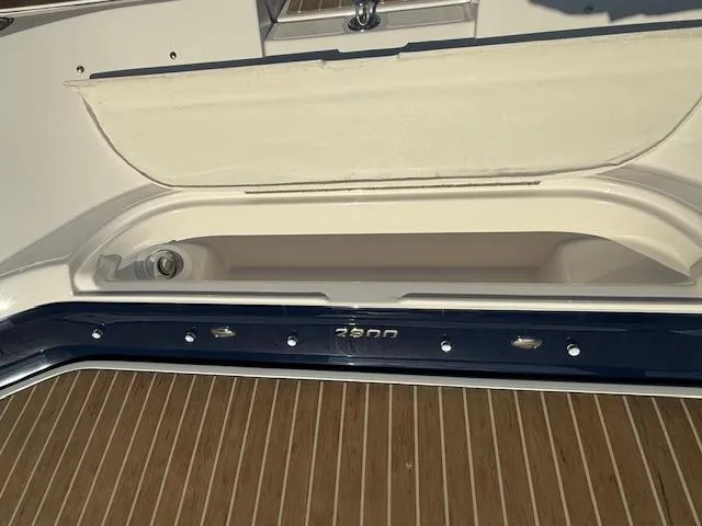 Slide: The Image of 2016 Regal 2800 Bowrider boat storage compartment with teak flooring. - 38
