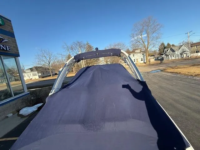 Slide: The Image of 2016 Regal 2800 Bowrider with cover, parked outdoors on a sunny day. - 44