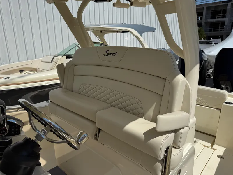 Slide: The Image of 2025 Scout 330 LXF boat interior with luxurious seating and steering wheel. - 13