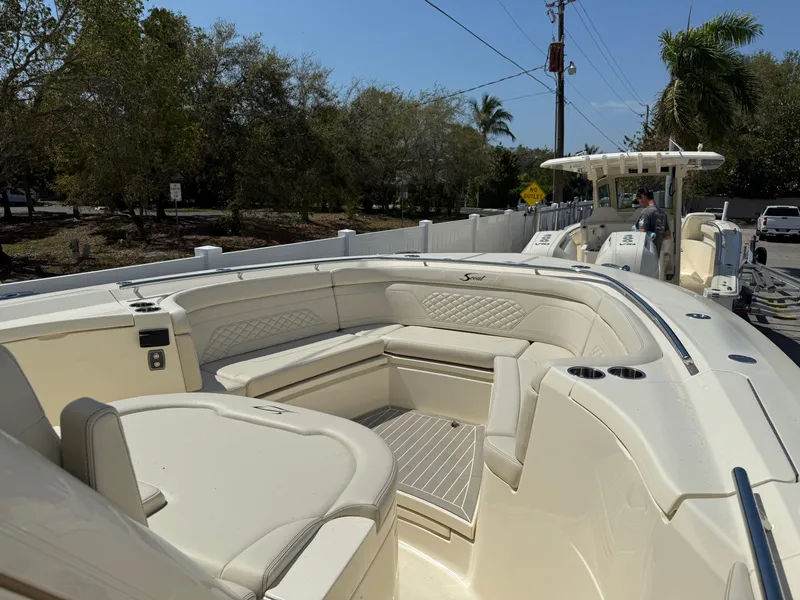 Slide: The Image of 2025 Scout 330 LXF boat with luxurious seating and sleek design. - 16