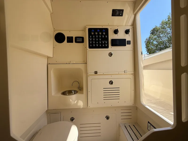 Slide: The Image of 2025 Scout 330 LXF boat interior with control panel, sink, and seating. - 22