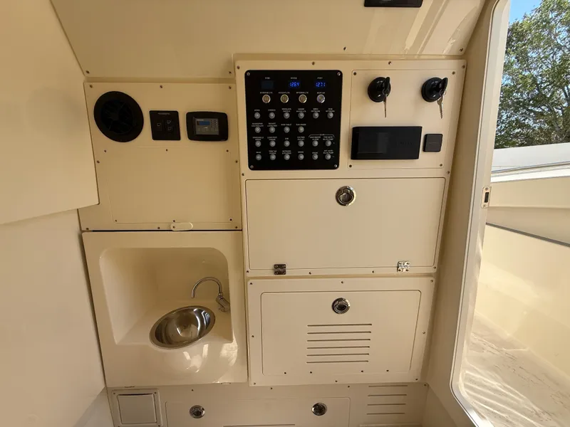 Slide: The Image of 2025 Scout 330 LXF boat interior with control panel and sink. - 23