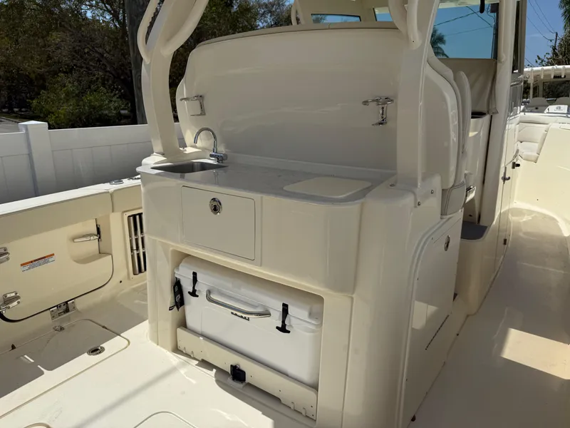 Slide: The Image of 2025 Scout 330 LXF boat interior with sink and storage area. - 8