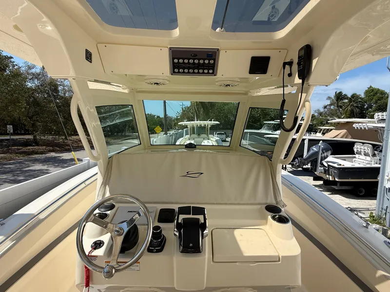Slide: The Image of 2025 Scout 330 LXF boat cockpit with steering wheel and control panel. - 9