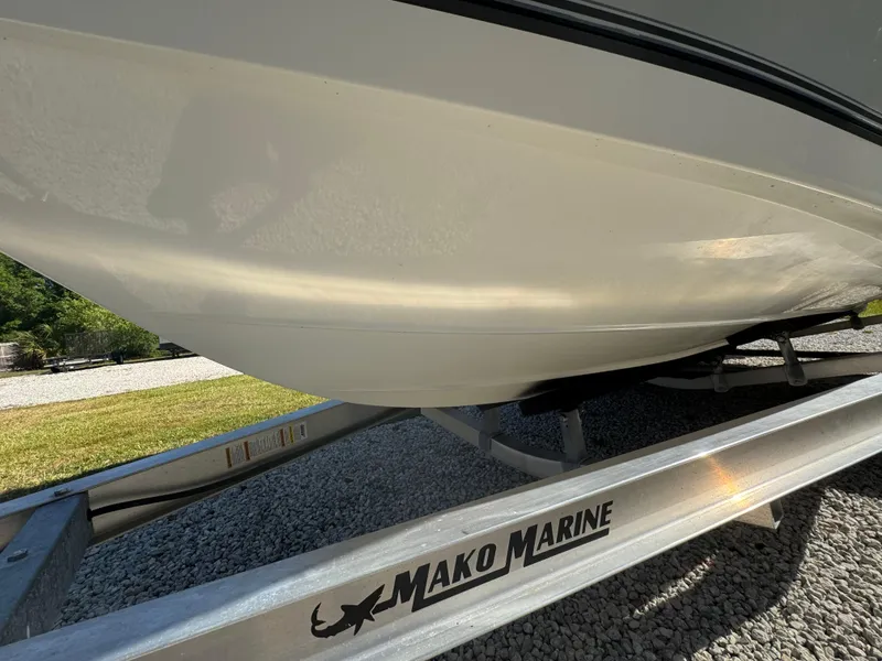 Slide: The Image of Mako 214C boat on trailer, 2019 model, displayed outdoors on gravel. - 23