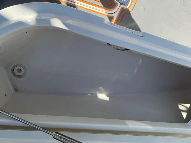 Slide: The Image of Open storage compartment on a 2019 Mako 214C boat, showing interior details. - 46
