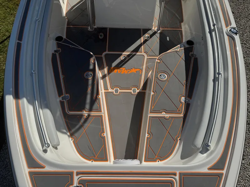 Slide: The Image of 2019 Mako 214C boat deck with custom non-slip flooring and storage compartments. - 49