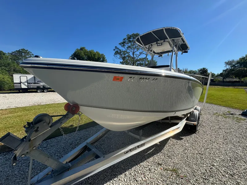 Slide: The Image of 2019 Mako 214C boat on trailer, parked outdoors under clear blue sky. - 8
