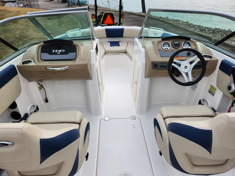 Slide: The Image of 2017 Chaparral 21 H2O Ski & Fish OB boat interior with beige and blue seating. - 11