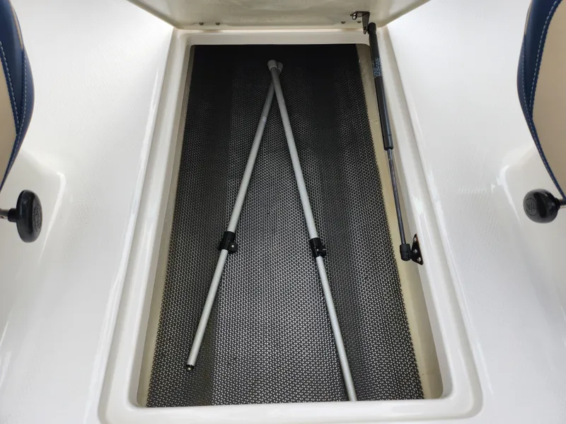 Slide: The Image of 2017 Chaparral 21 H2O Ski & Fish OB storage compartment with poles inside. - 12