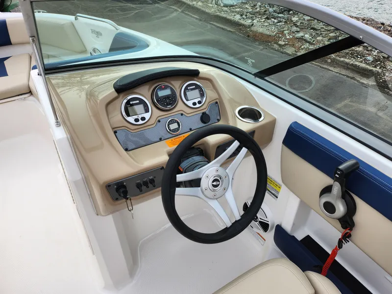 Slide: The Image of 2017 Chaparral 21 H2O Ski & Fish OB boat dashboard with steering wheel and gauges. - 15