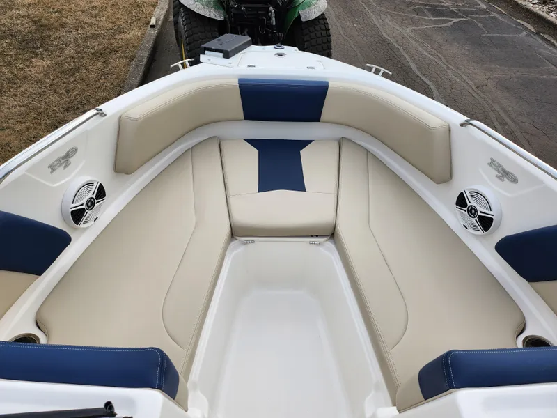 Slide: The Image of 2017 Chaparral 21 H2O Ski & Fish OB boat interior with beige and blue seating. - 19
