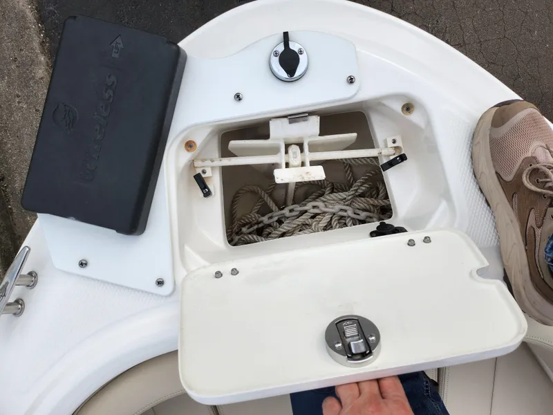 Slide: The Image of 2017 Chaparral 21 H2O Ski & Fish OB boat storage compartment with rope and accessories. - 22