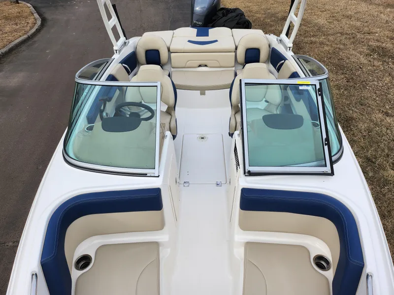 Slide: The Image of 2017 Chaparral 21 H2O Ski & Fish OB boat interior with beige and blue seating. - 24