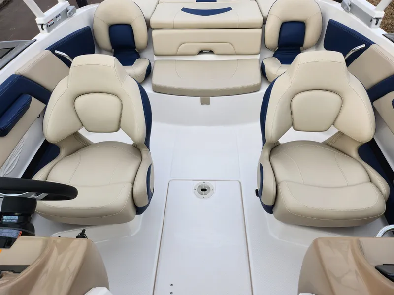 Slide: The Image of 2017 Chaparral 21 H2O Ski & Fish OB interior with beige and blue seating. - 25