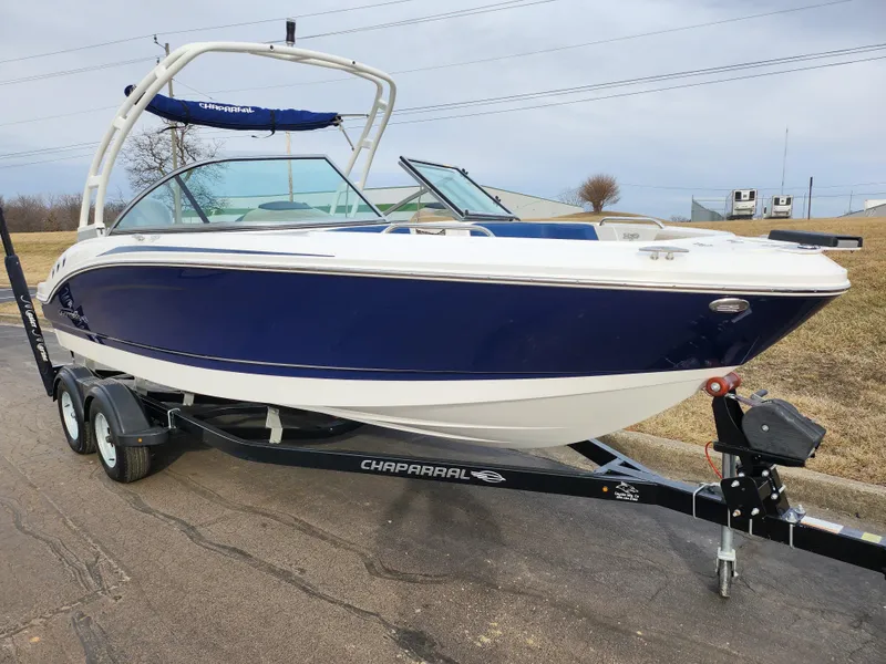 Slide: The Image of 2017 Chaparral 21 H2O Ski & Fish OB boat on trailer, blue and white design. - 5