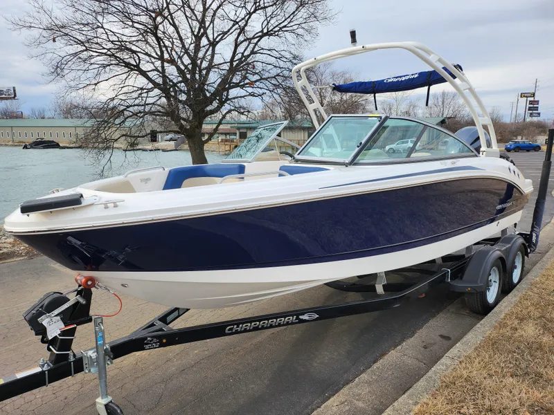 Slide: The Image of 2017 Chaparral 21 H2O Ski & Fish OB boat on trailer by a river. - 8