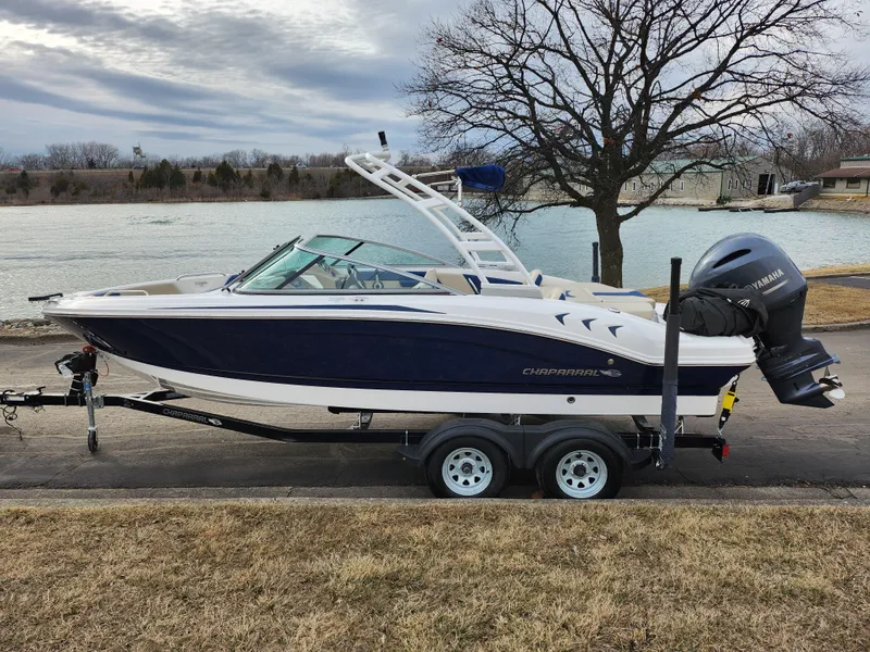 Slide: The Image of 2017 Chaparral 21 H2O Ski & Fish OB boat on trailer by a lake. - 9