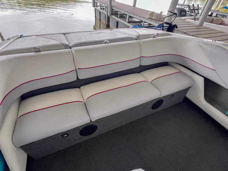 Slide: The Image of 1993 Chaparral 2200 SL boat interior with white and gray seating, dockside view. - 10