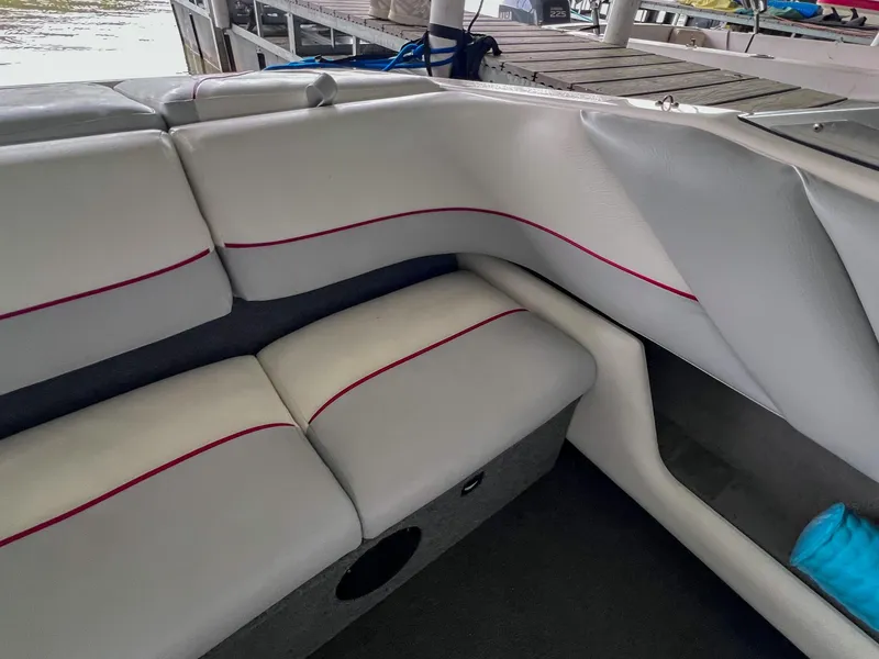 Slide: The Image of Interior seating of a 1993 Chaparral 2200 SL boat with white upholstery and red accents. - 13