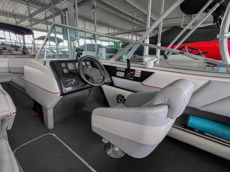 Slide: The Image of Interior of a 1993 Chaparral 2200 SL boat with steering wheel and seating. - 15