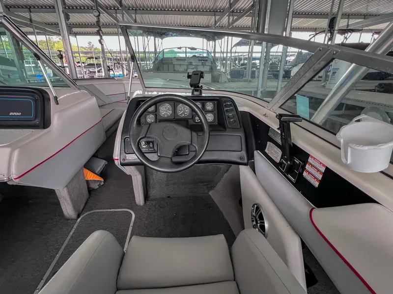 Slide: The Image of Interior of a 1993 Chaparral 2200 SL boat, featuring steering wheel and dashboard controls. - 16