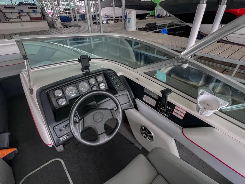 Slide: The Image of Interior view of a 1993 Chaparral 2200 SL boat dashboard with steering wheel and gauges. - 17
