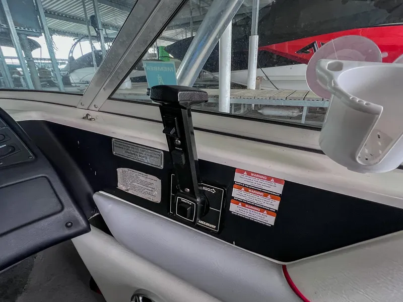 Slide: The Image of Interior of a 1993 Chaparral 2200 SL boat showing control panel and cup holder. - 18