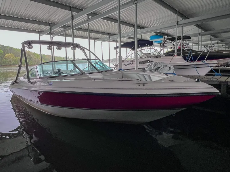 Slide: The Image of 1993 Chaparral 2200 SL boat docked in a covered marina. - 2
