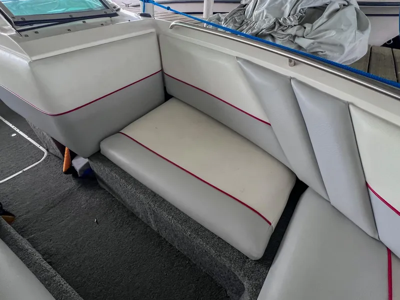 Slide: The Image of 1993 Chaparral 2200 SL boat interior with white and red-trimmed seating. - 28