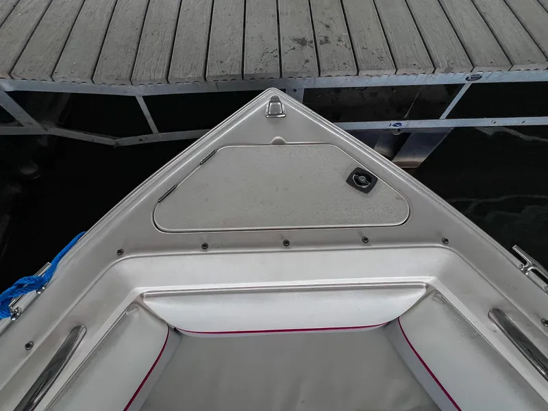 Slide: The Image of Bow of a 1993 Chaparral 2200 SL boat docked at a wooden pier. - 33