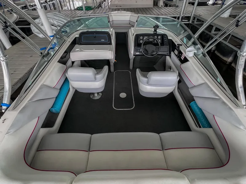 Slide: The Image of 1993 Chaparral 2200 SL boat interior with white seating and steering console. - 9